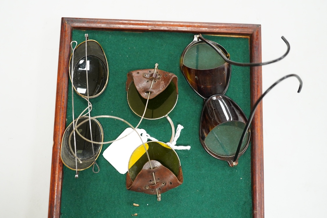 A pair of early 20th century Theodore Hamblin safety goggles with mesh wire sides, with original case, a pair of prescription mesh sided safety glasses, a pair of faux tortoiseshell safety glasses and a pair of Willson,